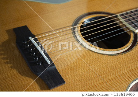 This is a close-up of the strings of an acoustic guitar. This is a close-up of the strings of an acoustic guitar. 135619400