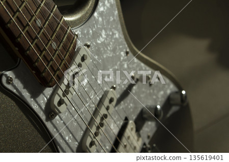 This is a close-up of the electric guitar strings. 135619401