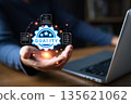 A person working on a laptop presents a glowing digital badge with the word quality surrounded by icons of approved documents, symbolizing excellence, certification, trust, and professional standards. 135621062