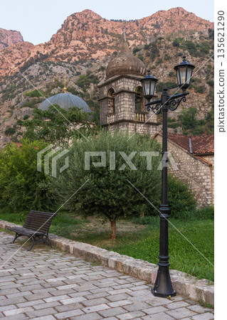 Kotor, Montenegro. A picturesque stone churches and a vintage street lamp 135621290