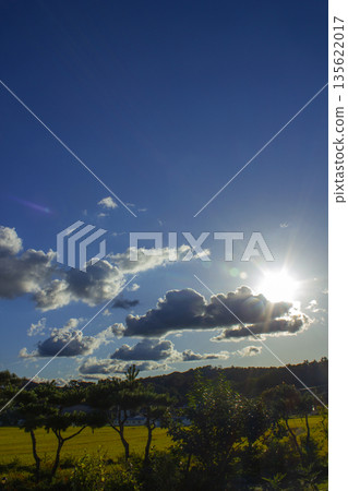 It's a blue sky with sunlight shining through it. 135622017
