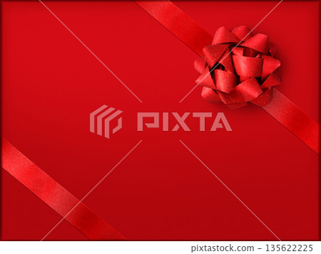 A stylish red ribbon bow on a red gift box. 135622225