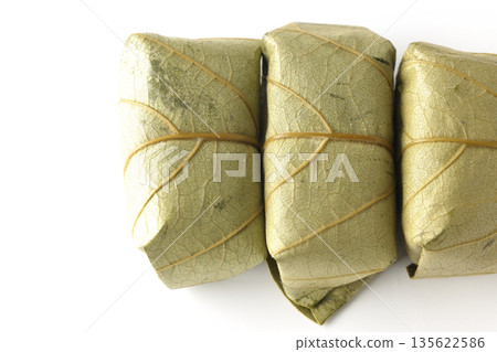 Persimmon leaf sushi photographed on a white background Persimmon leaf sushi photographed on a white background 135622586
