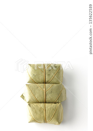 Persimmon leaf sushi photographed on a white background Persimmon leaf sushi photographed on a white background 135622589