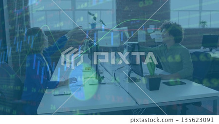 High-fiving coworkers sharing triumph at open office with monitors, stock graphs overlaying desks High-fiving coworkers sharing triumph at open office with monitors, stock graphs overlaying desks 135623091