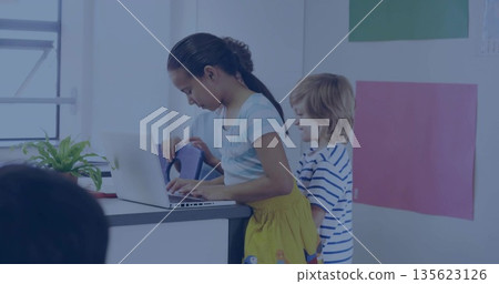 Typing girl wearing shirt and yellow skirt using laptop in school classroom, with poster boards Typing girl wearing shirt and yellow skirt using laptop in school classroom, with poster boards 135623126