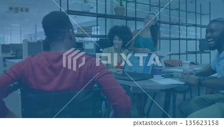 Coworkers discussing project around table in office, with laptop charts papers coffee cups plants Coworkers discussing project around table in office, with laptop charts papers coffee cups plants 135623158