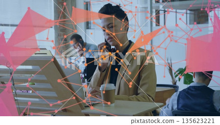 Holding coffee cup businesswoman speaking on smartphone in open office with network overlay Holding coffee cup businesswoman speaking on smartphone in open office with network overlay 135623221