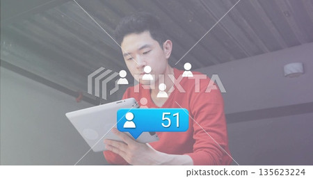 Man wearing red sweater viewing tablet on balcony, with user icons and 51 notification bubble Man wearing red sweater viewing tablet on balcony, with user icons and 51 notification bubble 135623224