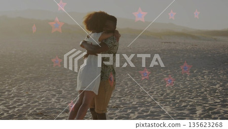 Lifting and embracing couple wearing sundress and tropical shirt on sandy beach during golden hour Lifting and embracing couple wearing sundress and tropical shirt on sandy beach during golden hour 135623268