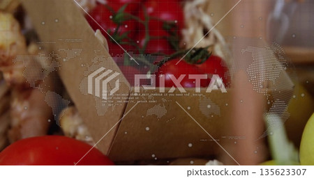 Featuring stemmed red tomatoes in box at stall, garlic bulbs, yellow onion, world map code overlay 135623307
