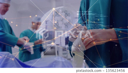 Male surgeon pulling sterile gloves on over gown in operating room, with digital globe, copy space Male surgeon pulling sterile gloves on over gown in operating room, with digital globe, copy space 135623456