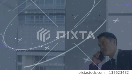 Talking man in business suit using smartphone by office windows with digital overlay, copy space Talking man in business suit using smartphone by office windows with digital overlay, copy space 135623482