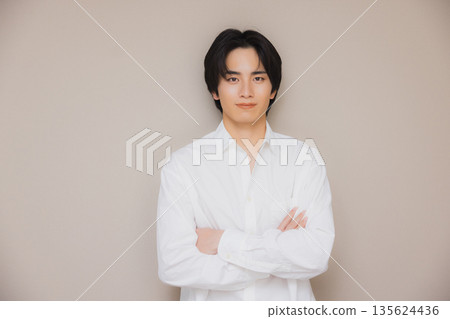 A man wearing a white shirt A man wearing a white shirt 135624436