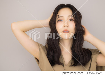 Woman in a beige dress Woman in a beige dress 135624525