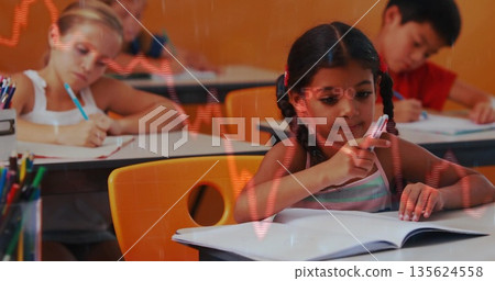Writing girl wearing striped tank top in classroom, with notebooks, colored pencil cup, data graphs Writing girl wearing striped tank top in classroom, with notebooks, colored pencil cup, data graphs 135624558