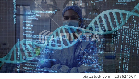 Female medical researcher inspecting floating DNA code on glass partition in lab, with lab benches 135624567