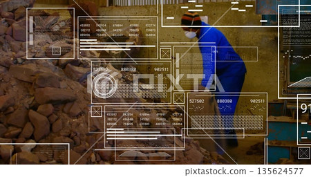 Man in blue coverall, mask monitoring data panels in processing plant, with rubble pile, copy space 135624577