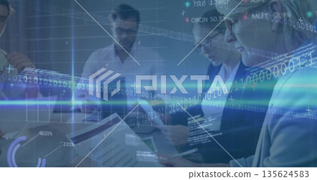 Reviewing professionals examining printed reports, tablet and data overlays around conference table 135624583