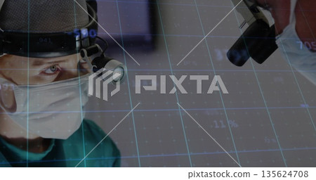 Male surgeon wearing green gown focusing gaze on imaging device in OR, with digital grid overlay Male surgeon wearing green gown focusing gaze on imaging device in OR, with digital grid overlay 135624708