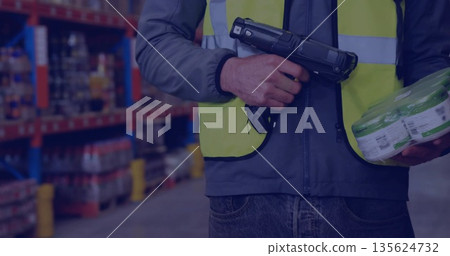 Scanning worker wearing safety vest using barcode scanner in storage aisle with product pack Scanning worker wearing safety vest using barcode scanner in storage aisle with product pack 135624732