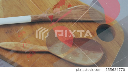 Showing spatula and spoon resting on cutting board at kitchen workspace, with digital HUD 135624770