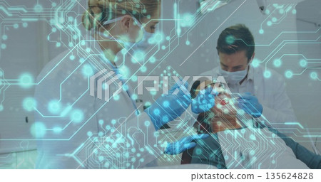 Receiving oral care female patient reclining in dental chair in clinic, with circuit board overlay Receiving oral care female patient reclining in dental chair in clinic, with circuit board overlay 135624828