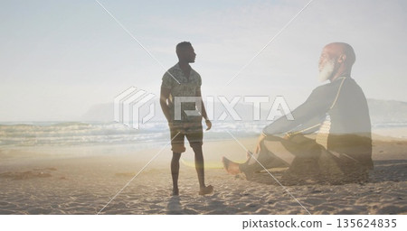 Standing man gazing at horizon on sandy shore, with meditating father overlay, waves and hills Standing man gazing at horizon on sandy shore, with meditating father overlay, waves and hills 135624835
