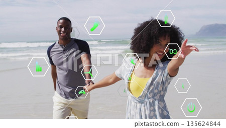 Running couple holding hands along wet sand at beach shoreline, with hexagonal graphic overlays Running couple holding hands along wet sand at beach shoreline, with hexagonal graphic overlays 135624844
