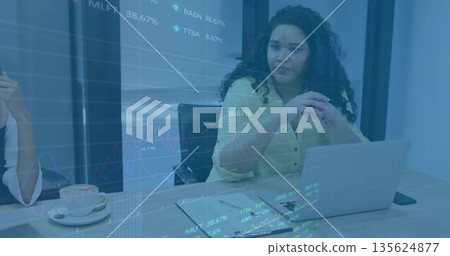 Reviewing projected stock market charts on wooden table in meeting room, with laptop coffee cup Reviewing projected stock market charts on wooden table in meeting room, with laptop coffee cup 135624877