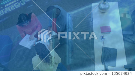 Three workers in business attire reviewing paperwork in office, with binder and laptop, copy space Three workers in business attire reviewing paperwork in office, with binder and laptop, copy space 135624924