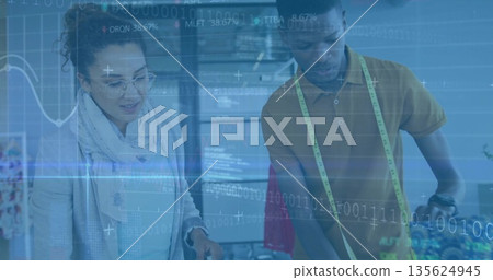 Design collaborators inspecting garment prototype in design studio, with digital overlays 135624945