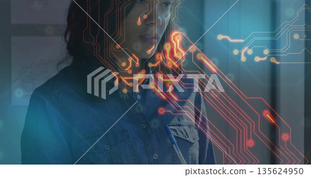 Studying Asian tech professional scanning floating circuit overlay in modern lab, with pen pocket 135624950