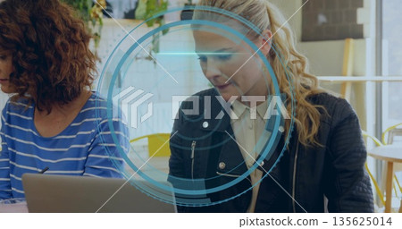 Typing woman in black jacket using laptop at cafe, with digital overlay, coffee mug, copy space 135625014