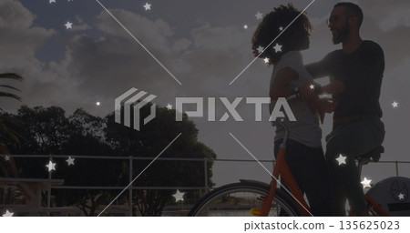 Couple looking at each other at waterfront railing, with orange bicycle and boats, copy space Couple looking at each other at waterfront railing, with orange bicycle and boats, copy space 135625023