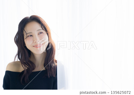 A woman basking in the morning sun 135625072