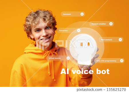 Young person in orange hoodie shows AI voice bot and its functions for various tasks Young person in orange hoodie shows AI voice bot and its functions for various tasks 135625270