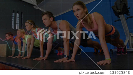 Performing push-ups workout group holding high plank on raised platform in gym, with graph overlay 135625848