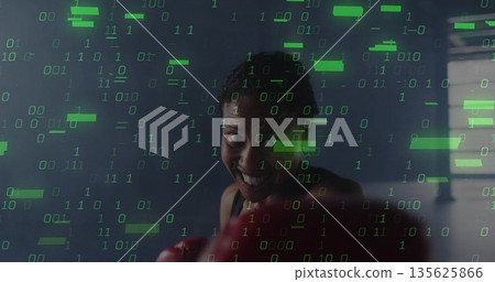 Punching boxer in tank top with red gloves by boxing gym ring ropes, with binary overlay Punching boxer in tank top with red gloves by boxing gym ring ropes, with binary overlay 135625866