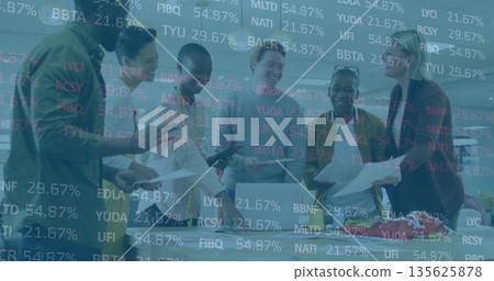 Finance team in business casual attire reviewing financial data in boardroom with reports, devices 135625878