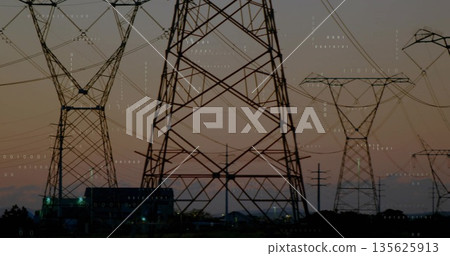 Dominating steel lattice tower standing with power lines above substation at dusk, binary overlay 135625913