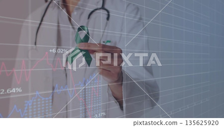 Physician wearing lab coat stethoscope holding green awareness ribbon in data grid with line charts Physician wearing lab coat stethoscope holding green awareness ribbon in data grid with line charts 135625920