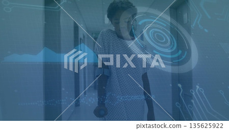 Walking girl talking on smartphone using crutches in hospital corridor, with interface overlay Walking girl talking on smartphone using crutches in hospital corridor, with interface overlay 135625922