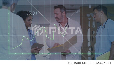 Medical team reviewing charts in hospital corridor, with tablet, clipboards and digital overlay Medical team reviewing charts in hospital corridor, with tablet, clipboards and digital overlay 135625923