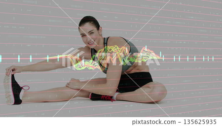 Stretching woman wearing gray sports bra black shorts and sneakers in studio, neon waveform overlay Stretching woman wearing gray sports bra black shorts and sneakers in studio, neon waveform overlay 135625935