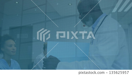 Holding blue folder, doctor with stethoscope presenting it to colleagues in clinic, copy space 135625957