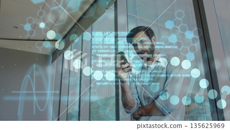Standing bearded man scanning smartphone in glass hallway, displaying digital overlays, copy space Standing bearded man scanning smartphone in glass hallway, displaying digital overlays, copy space 135625969