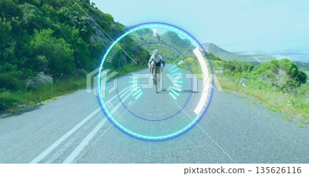 Riding cyclist pedaling along mountain road wearing full cycling gear, road bike, heads-up overlay Riding cyclist pedaling along mountain road wearing full cycling gear, road bike, heads-up overlay 135626116
