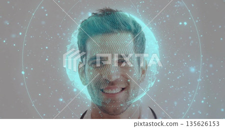 Smiling doctor wearing white coat, stethoscope in studio, displaying globe grid with particles 135626153