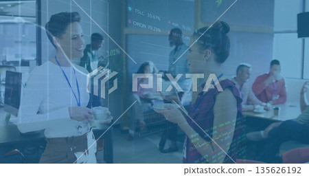 Holding coffee cups and saucers, professional women chatting in office break room, with badges Holding coffee cups and saucers, professional women chatting in office break room, with badges 135626192